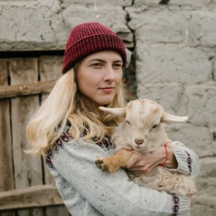 Young woman holding a goat